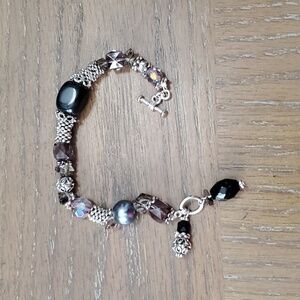 Beautiful beaded silver tone with bracelet with blue,grey, black bead work.